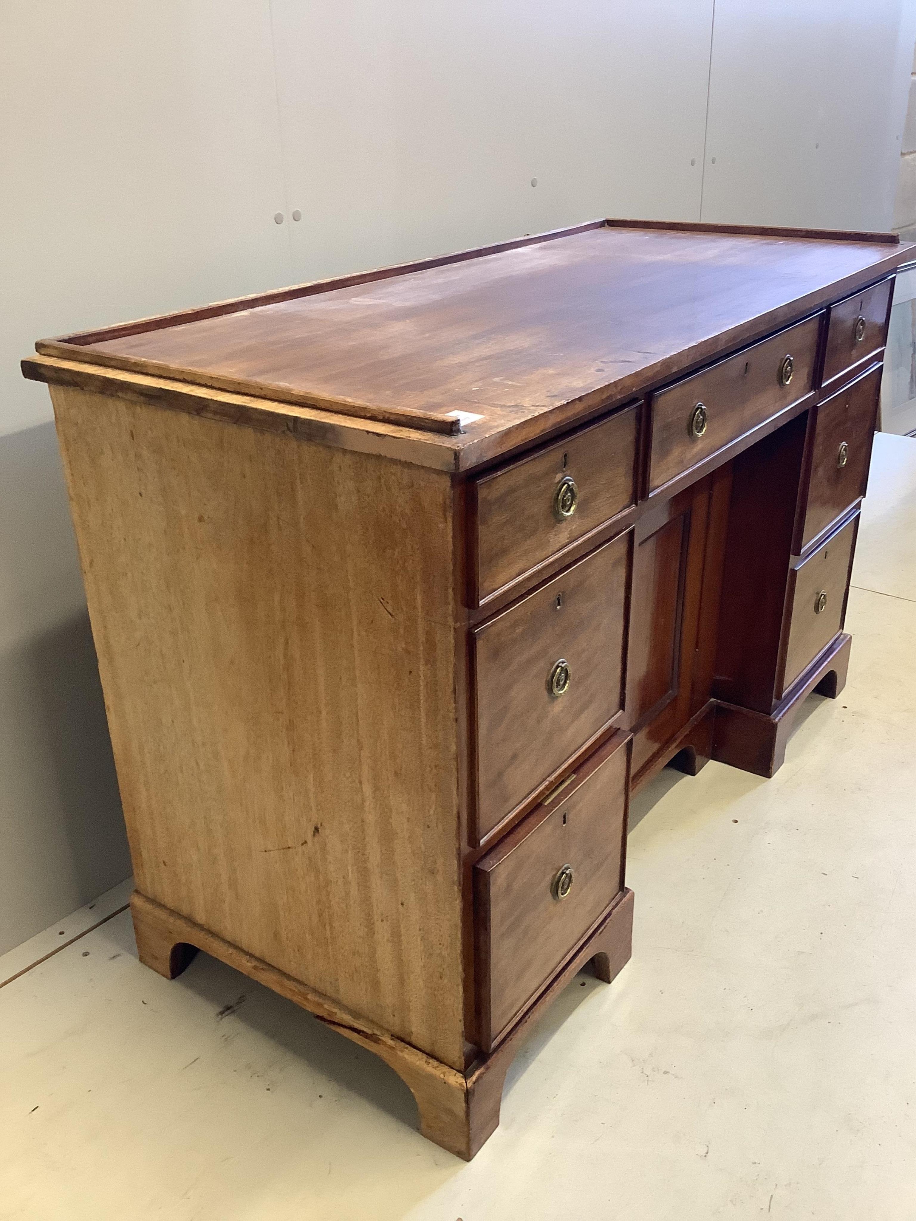 A Regency mahogany galleried topped dressing chest, fitted seven drawers, about a kneehole cupboard, width 127cm, depth 55cm, height 83cm. Condition - fair